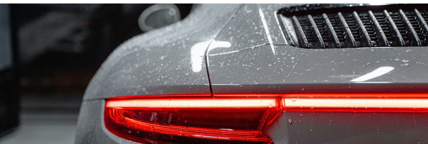 Back view of gray car with water spots 