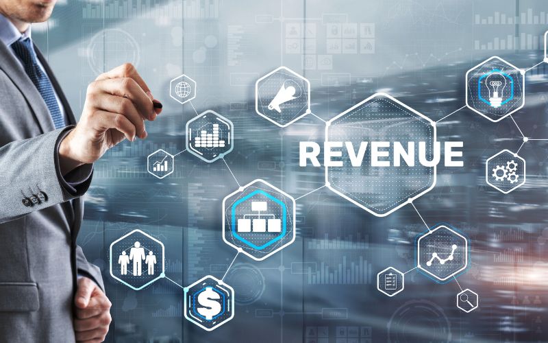 Man pointing to screen with the word revenue on it