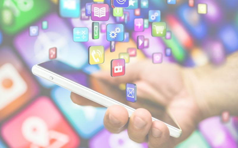 Person holding phone and apps displayed