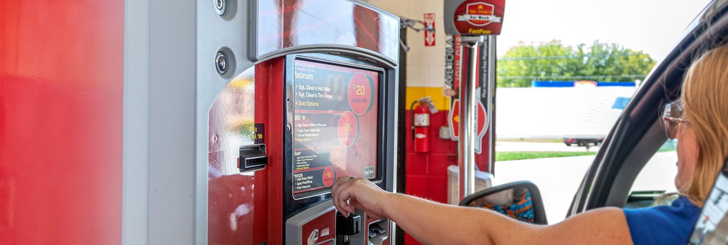 car wash customer reaches out to use touchscreen on DRB's XPT pay station