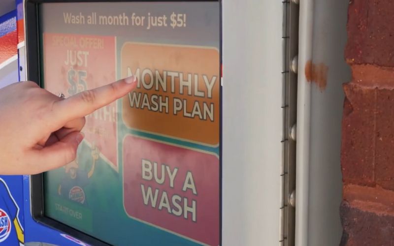 evolution_of_car_wash_memberships.jpg Finger reaching out to touch monthly wash plan option on car wash pay station screen