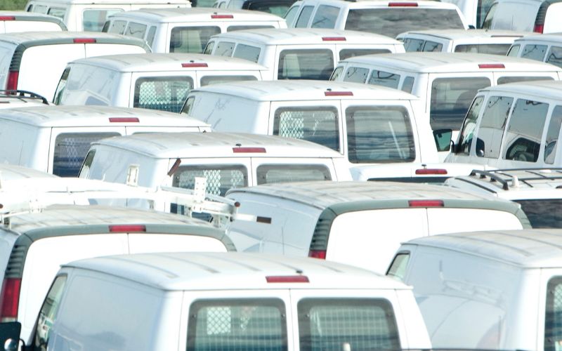 several white vans parked together
