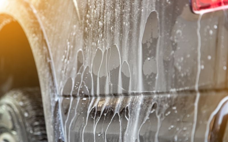 soapy water running off a vehicle near the tire