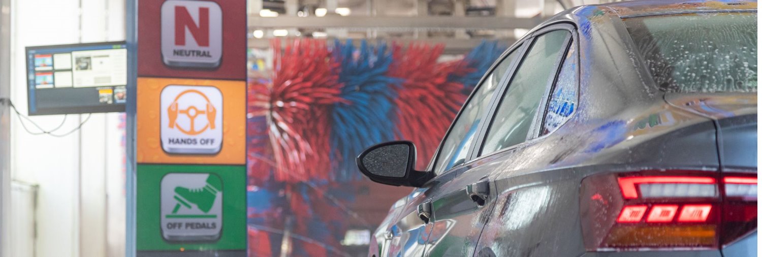 Car at colorful car wash station