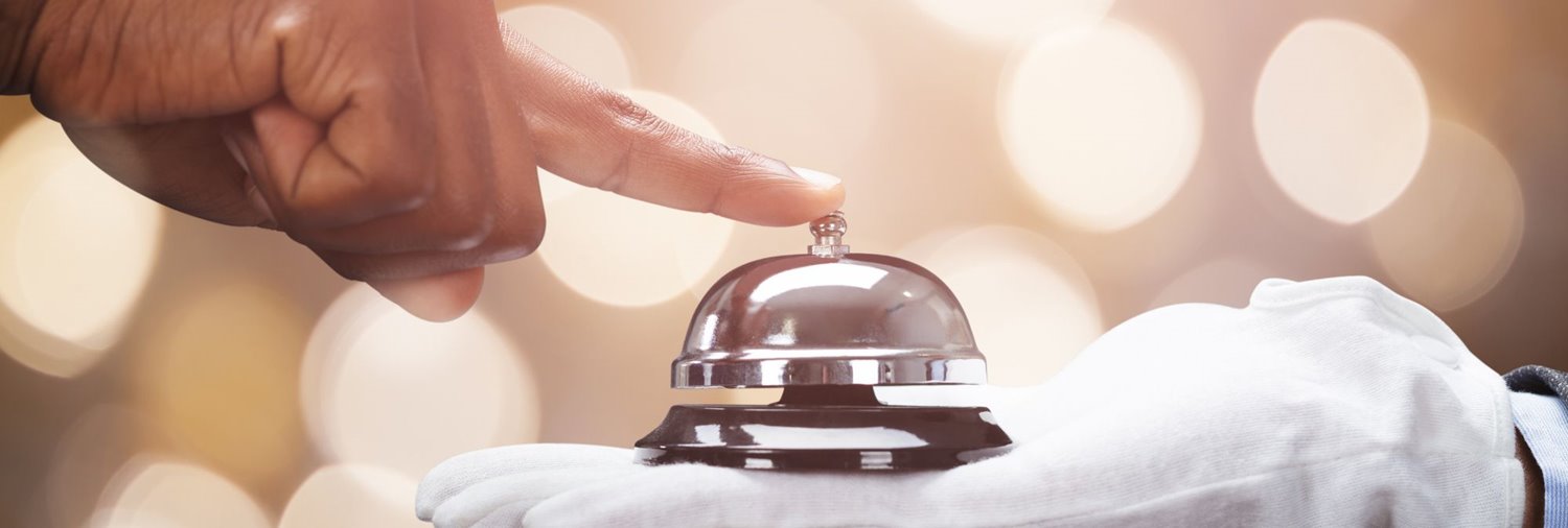 Gloved hand holding a bell