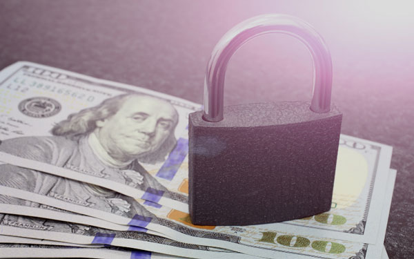 A lock on top of cash representing how Portal TI+ helps keep cash safe at the car wash