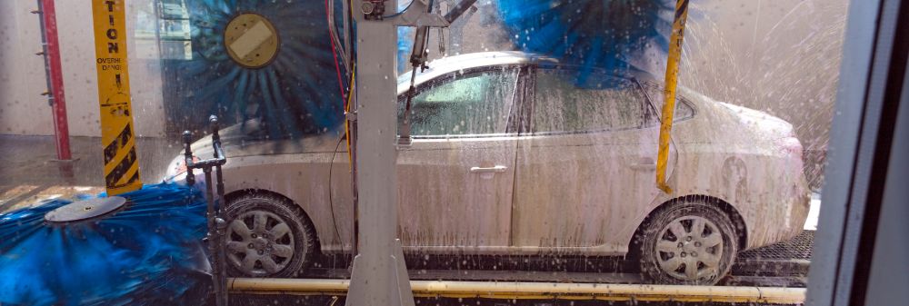 white car going through a car wash tunnel