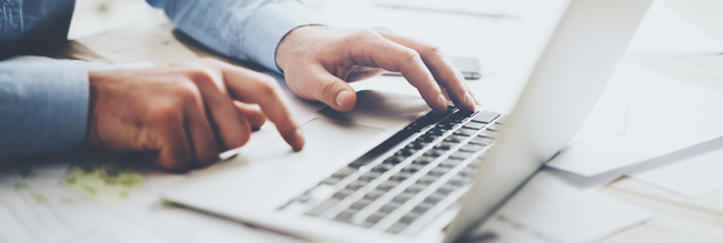 Man typing on a laptop computer
