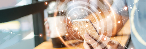 a out-of-focus hand holding a phone overlayed with graphics of people and orbs