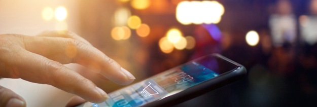 mobile phone in someone's hand displaying cart icon