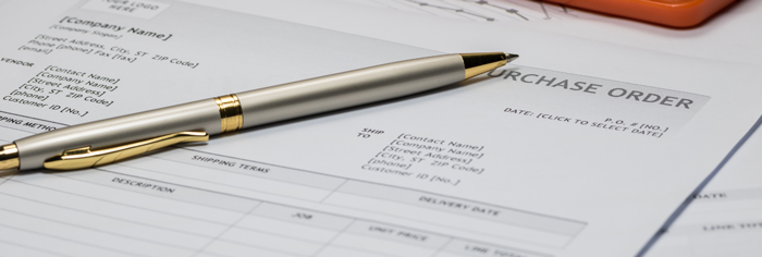 pen on top of a purchase order