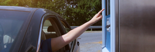 car wash customer reaching out to use a DRB in-bay automatic car wash pay station built by Unitec